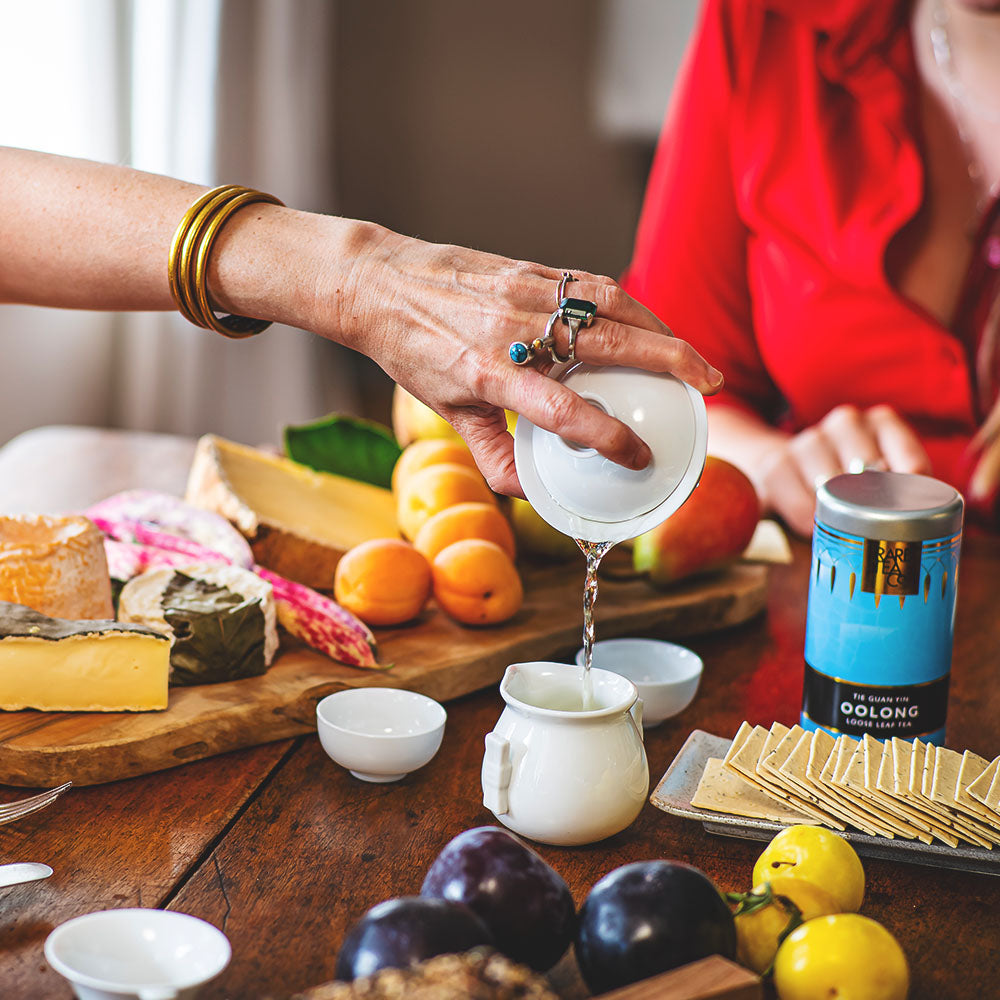 women pouring a mug of Chinese Tie Guan Yin Oolong loose leaf tea
