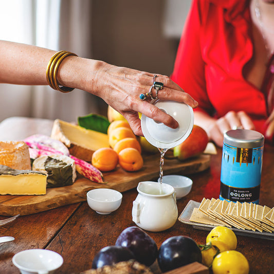 women pouring a mug of Chinese Tie Guan Yin Oolong loose leaf tea